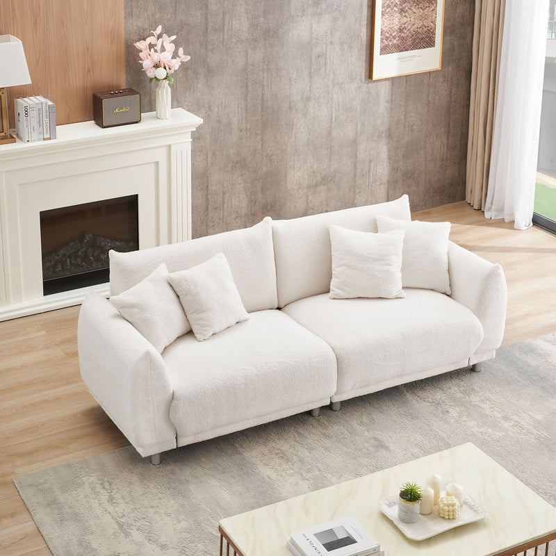 Teddy Wool Beige Sofa With Four Throw Pillows And Hardware Feet Can Sit Comfortably In An Apartment Bedroom Without Taking Up Space